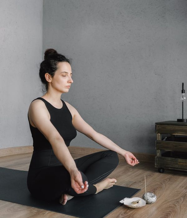 Woman feeling energetic and balanced in a modern living room.